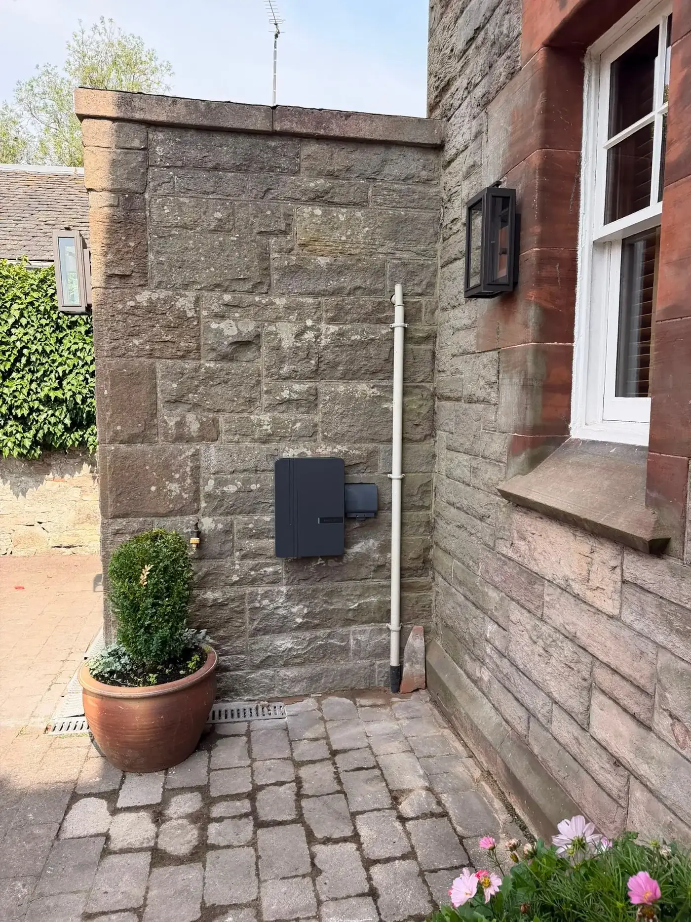 Completed EV charger installation on a Scottish sandstone home