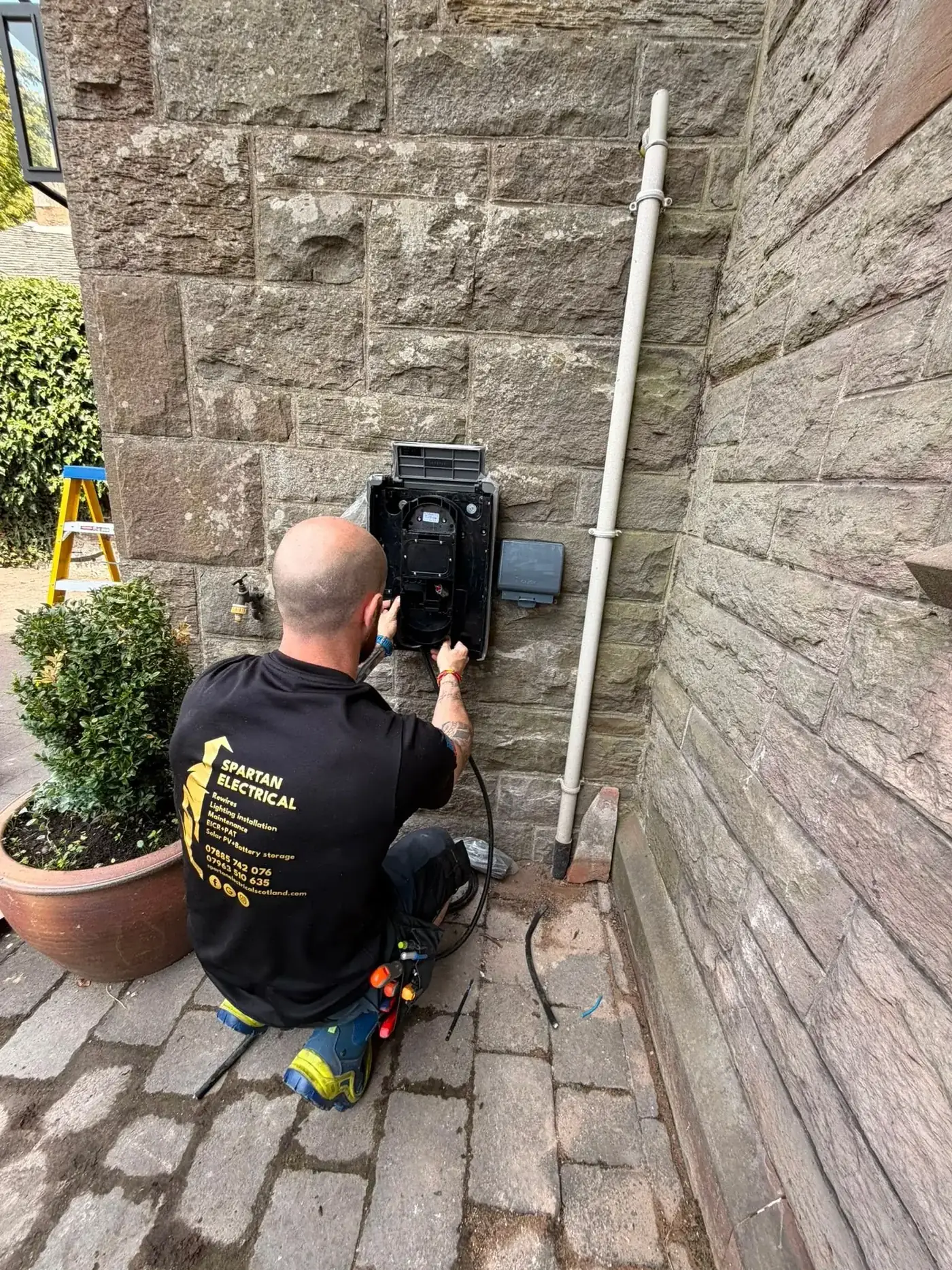 Close-up of Spartan Electrical engineer commissioning a new EV charger unit