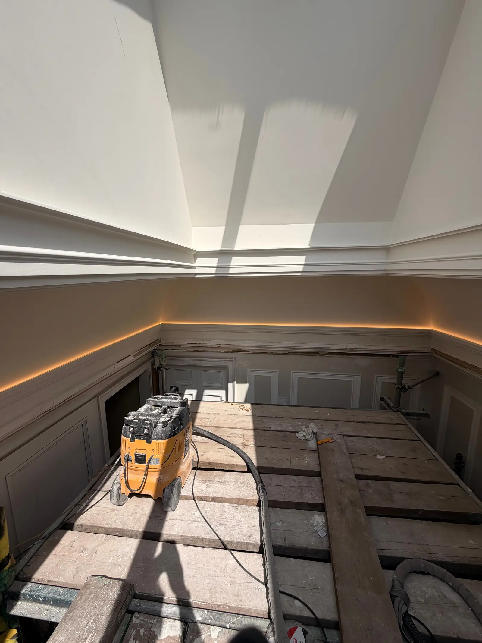 Warm LED cove lighting fitted above panelling in a period Edinburgh property