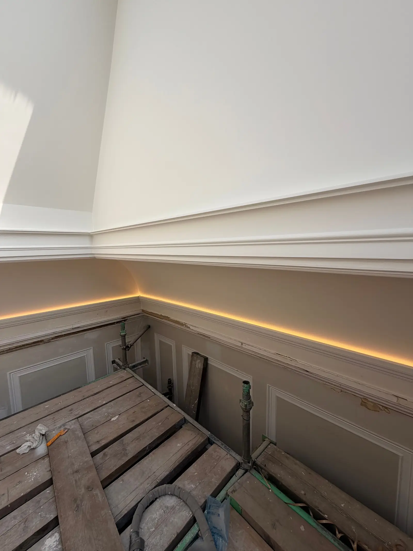 Concealed LED strip lighting running along a cornice, installed by Spartan Electrical