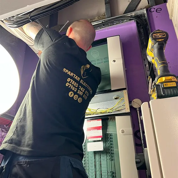 Spartan Electrical engineer in branded uniform on a rewire