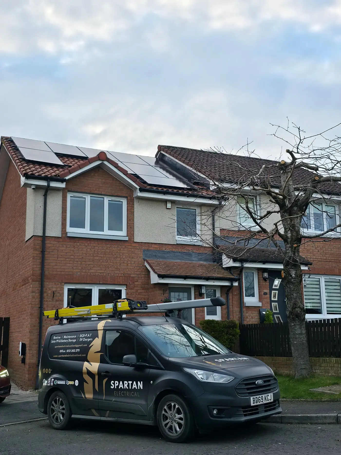 Spartan Electrical van outside a Scottish home with a completed solar PV install on the roof