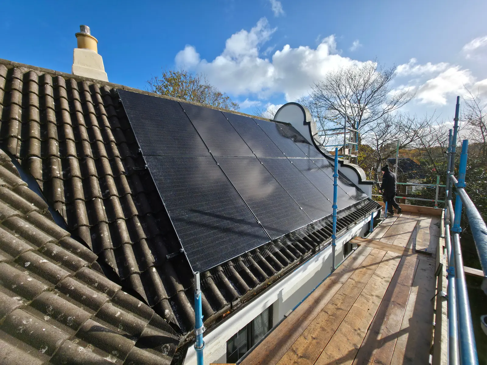 Completed solar PV array on a Scottish slate roof, installed by Spartan Electrical